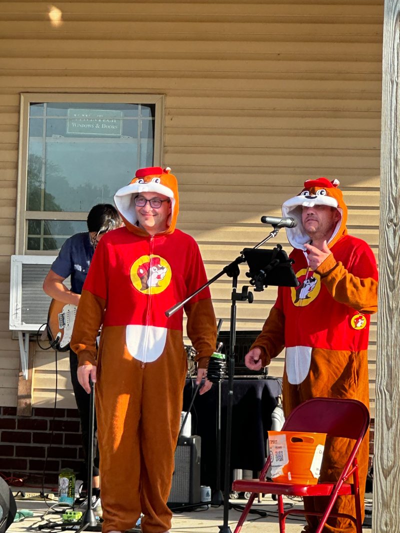 MCs in costume on the covered porch stage