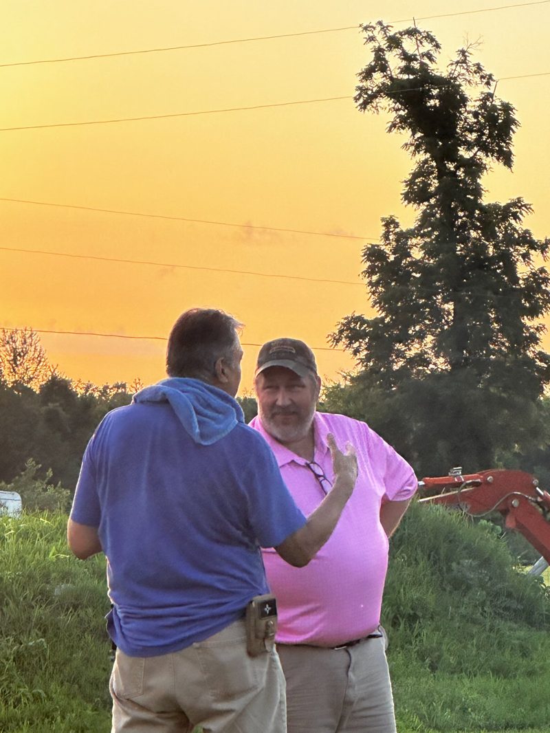 Friends chatting at sunset with amber Tennessee sky