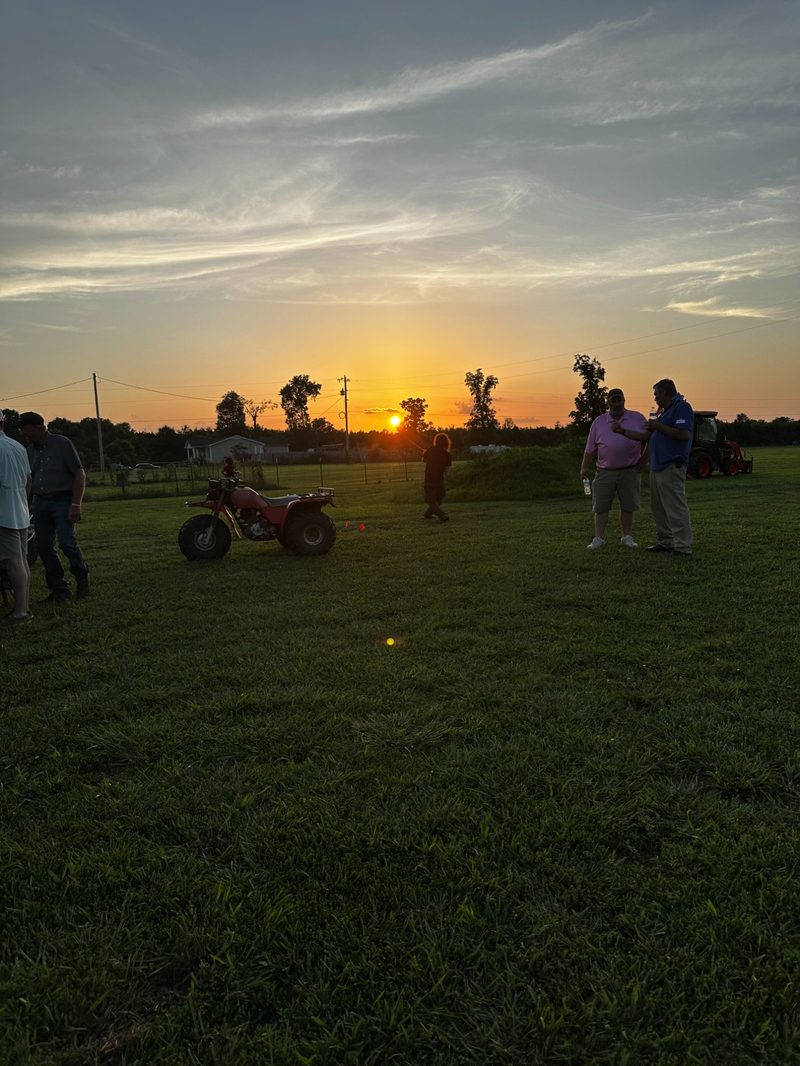 Golden hour sunset over the field with guests socializing