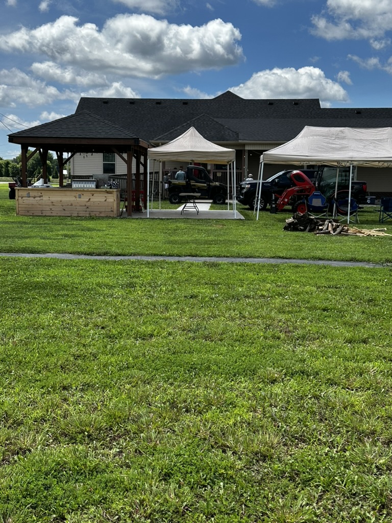 Wide view of the property with gazebo, tents and field